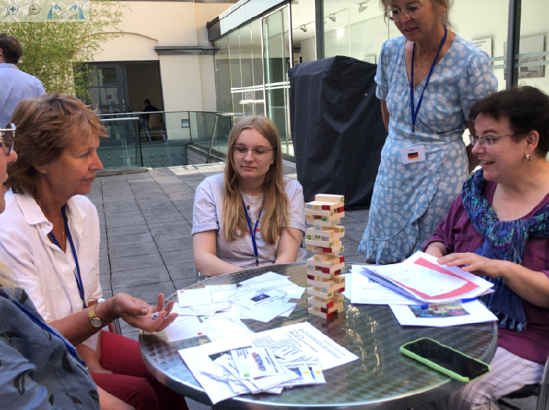 This group of players uses a standard sized "Jenga" game. In our main version in our community centre in Pécs (Hungary), we prefer using a giant set of wood blocks to build the tower. 