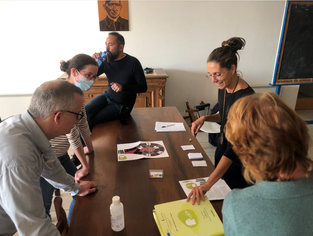 Testing the game (here yet with a preliminary game bord) during the project management meeting in Verona, October 2021. 